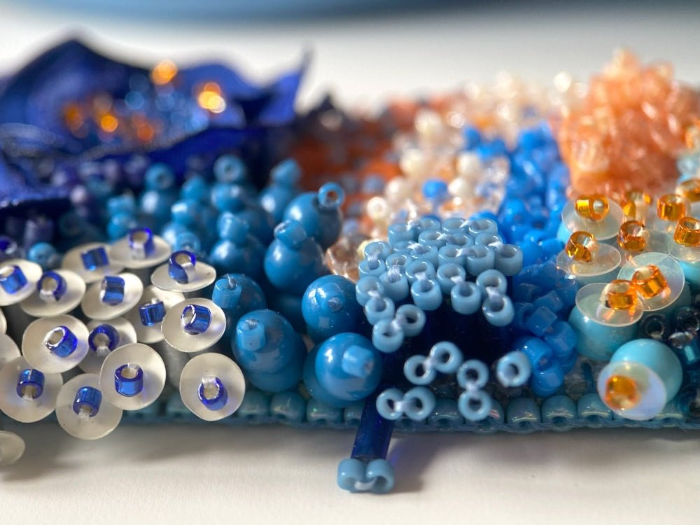 Exclusive statement volume-beaded bracelet in deep blue, orange and matte silver hues crafted from beads, sequins, textile and natural stones - Ornamentico shop