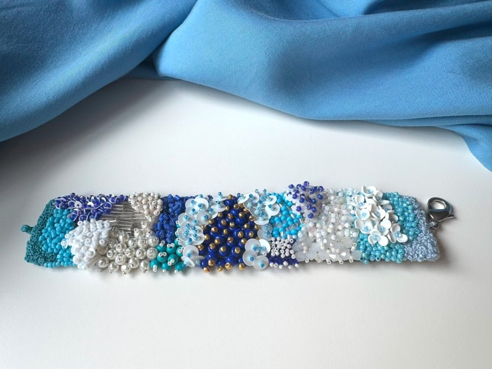 Exclusive handmade bracelet crafted from beads, sequins and rhinestones in a variety of blue and white hues using volume-beading technique - Ornamentico shop