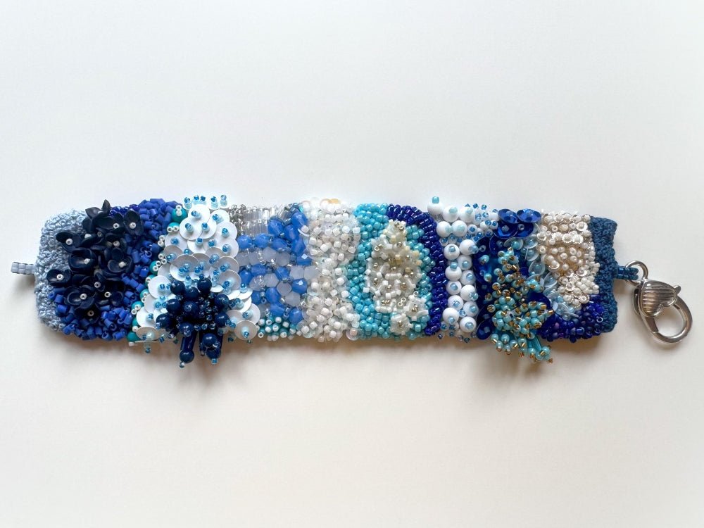 Exclusive handmade bracelet crafted from beads, sequins and rhinestones in a variety of blue and white hues using volume-beading technique - Ornamentico shop