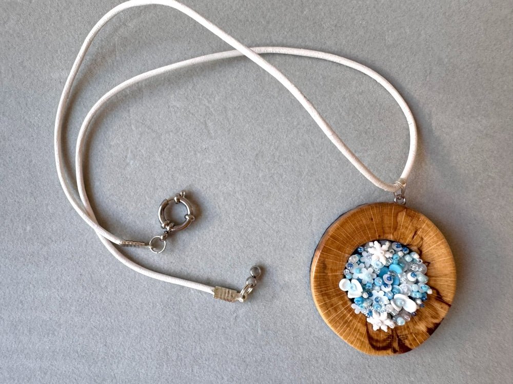 Exclusive wooden pendant with volume-beaded inlay crafted in floral motif using light blue and white hues - Ornamentico shop