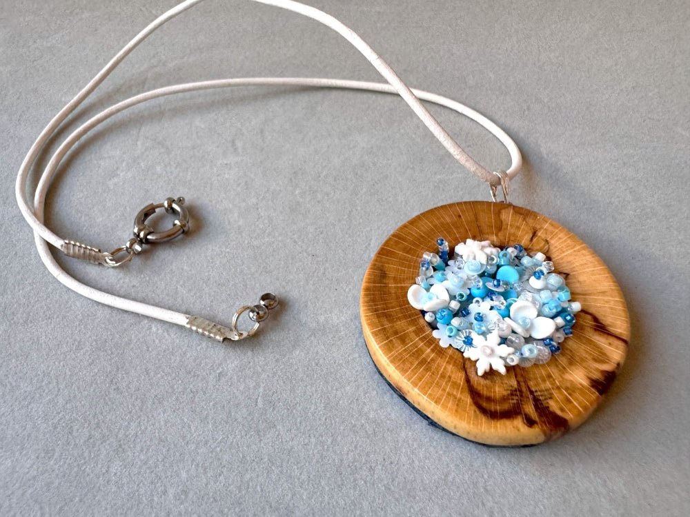 Exclusive wooden pendant with volume-beaded inlay crafted in floral motif using light blue and white hues - Ornamentico shop