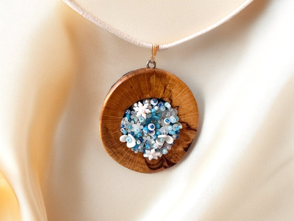 Exclusive wooden pendant with volume-beaded inlay crafted in floral motif using light blue and white hues - Ornamentico shop