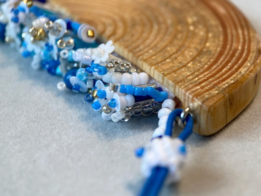 Exclusive wooden pendant with embedded beaded element imitating flowerbed with various hues of blue and white - Ornamentico shop