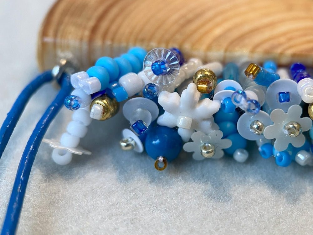 Exclusive wooden pendant with embedded beaded element imitating flowerbed with various hues of blue and white - Ornamentico shop