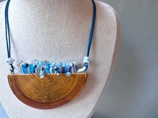 Exclusive wooden pendant with embedded beaded element imitating flowerbed with various hues of blue and white - Ornamentico shop