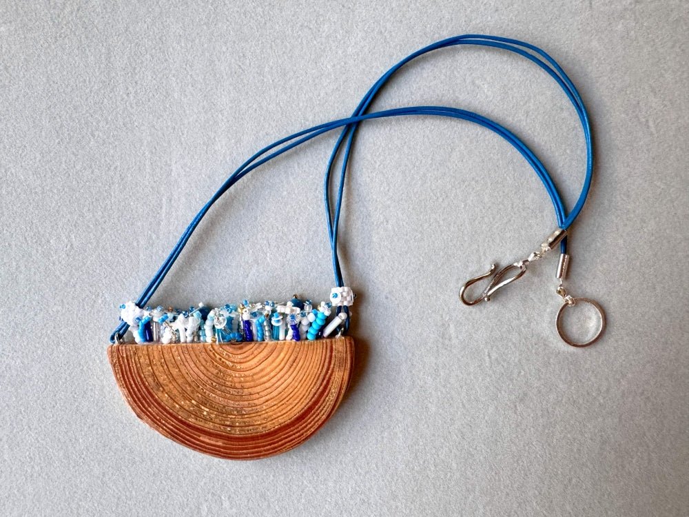 Exclusive wooden pendant with embedded beaded element imitating flowerbed with various hues of blue and white - Ornamentico shop