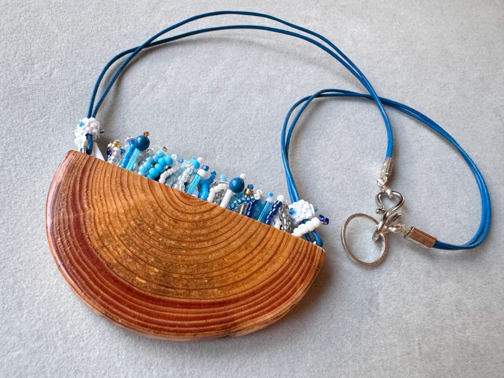 Exclusive wooden pendant with embedded beaded element imitating flowerbed with various hues of blue and white - Ornamentico shop