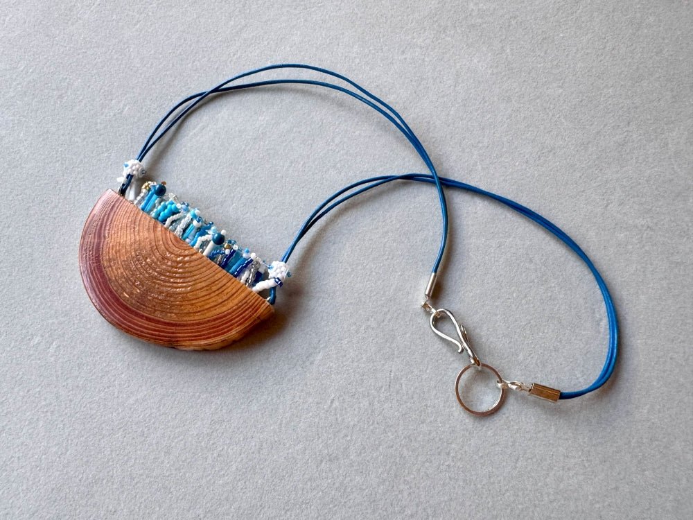 Exclusive wooden pendant with embedded beaded element imitating flowerbed with various hues of blue and white - Ornamentico shop