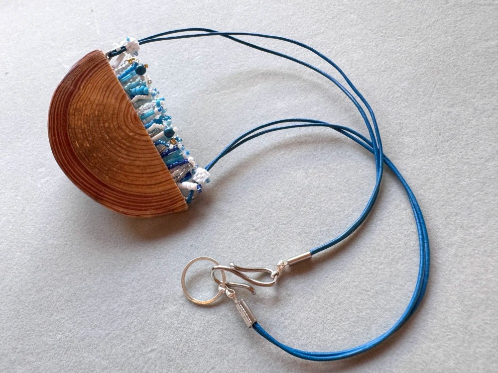 Exclusive wooden pendant with embedded beaded element imitating flowerbed with various hues of blue and white - Ornamentico shop