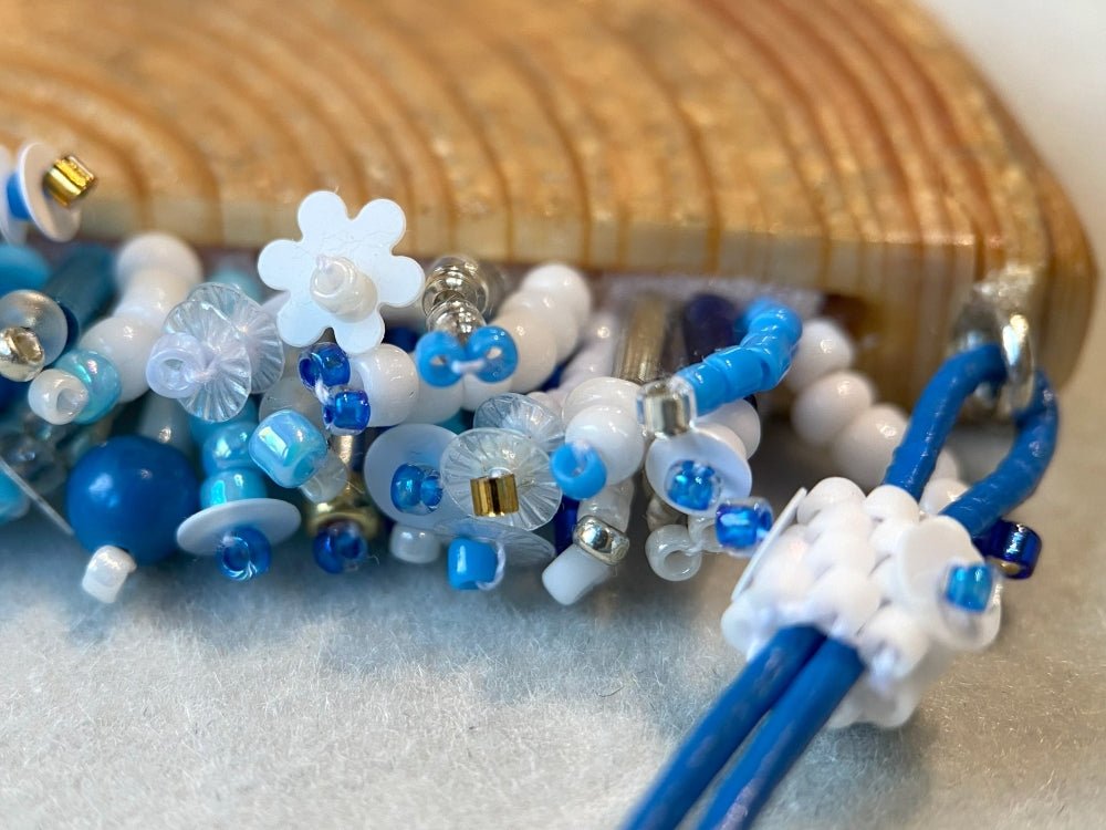 Exclusive wooden pendant with embedded beaded element imitating flowerbed with various hues of blue and white - Ornamentico shop