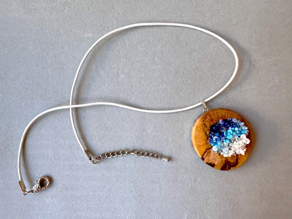 Exclusive wooden pendant with volume-beaded center crafted in elegant gradient white-to-blue colors - Ornamentico shop