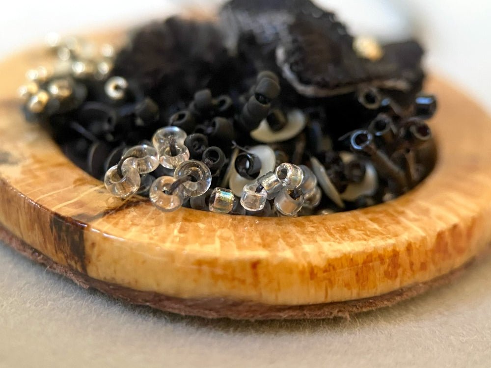 Exclusive wooden pendant with textile and volume-beaded floral inlay crafted in elegant black