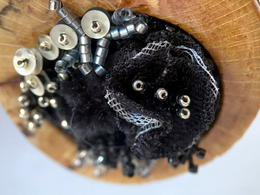 Exclusive wooden pendant with textile and volume-beaded floral inlay crafted in elegant black
