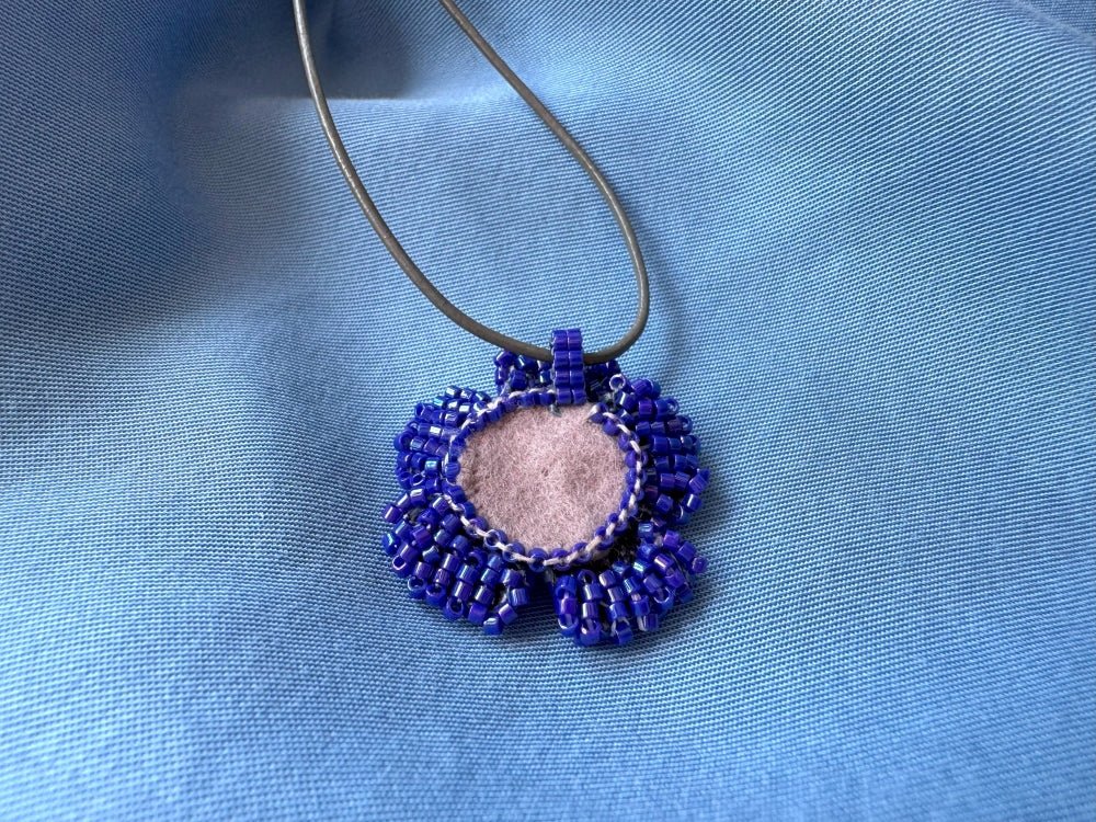 Handmade 360° beaded pendant inspired by blue clematis. Indigo to crystal tones, with leather cord - Ornamentico shop