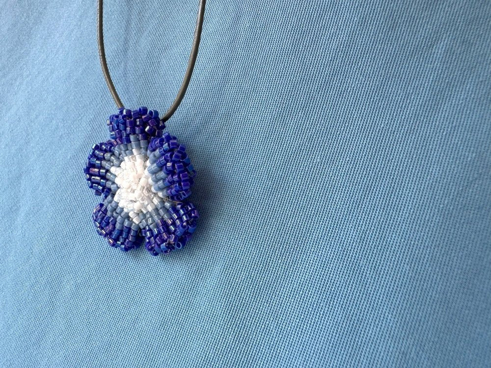 Handmade 360° beaded pendant inspired by blue clematis. Indigo to crystal tones, with leather cord - Ornamentico shop