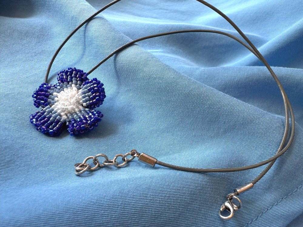 Handmade 360° beaded pendant inspired by blue clematis. Indigo to crystal tones, with leather cord - Ornamentico shop