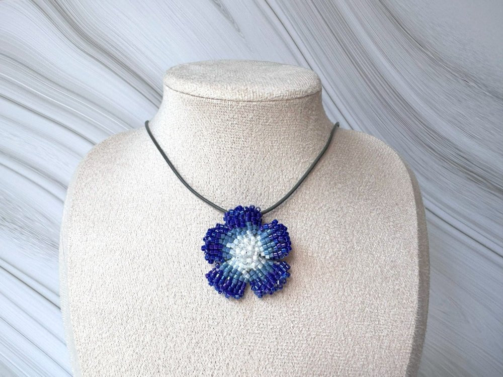 Handmade 360° beaded pendant inspired by blue clematis. Indigo to crystal tones, with leather cord - Ornamentico shop