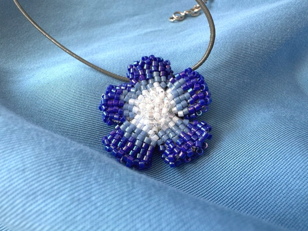 Handmade 360° beaded pendant inspired by blue clematis. Indigo to crystal tones, with leather cord - Ornamentico shop
