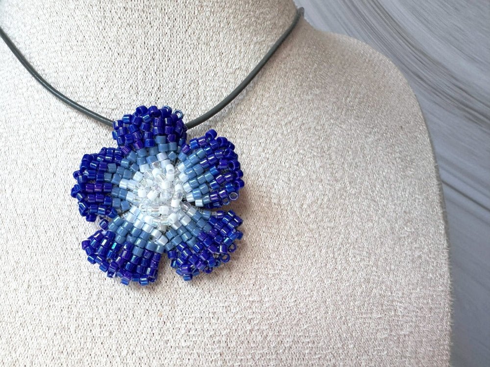 Handmade 360° beaded pendant inspired by blue clematis. Indigo to crystal tones, with leather cord - Ornamentico shop