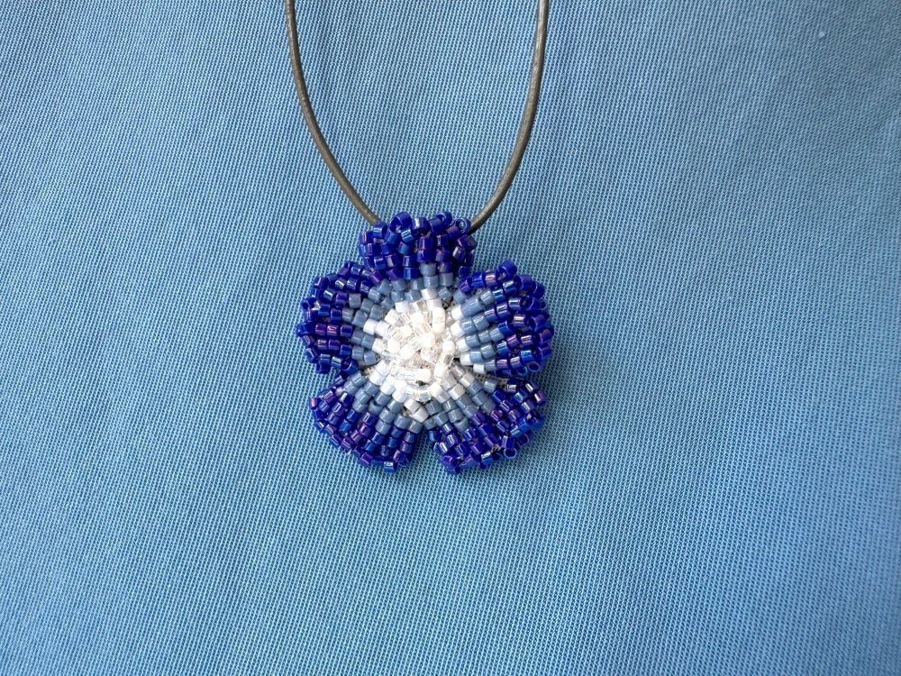 Handmade 360° beaded pendant inspired by blue clematis. Indigo to crystal tones, with leather cord - Ornamentico shop