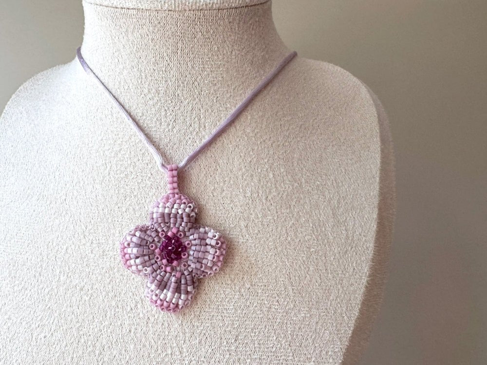 Sculptural floral pendant in soft pink to burgundy tones. Hand-beaded rosette design with silk cord - Ornamentico shop