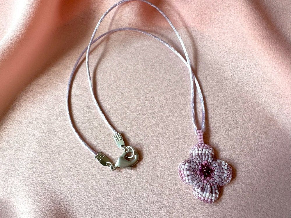 Sculptural floral pendant in soft pink to burgundy tones. Hand-beaded rosette design with silk cord - Ornamentico shop