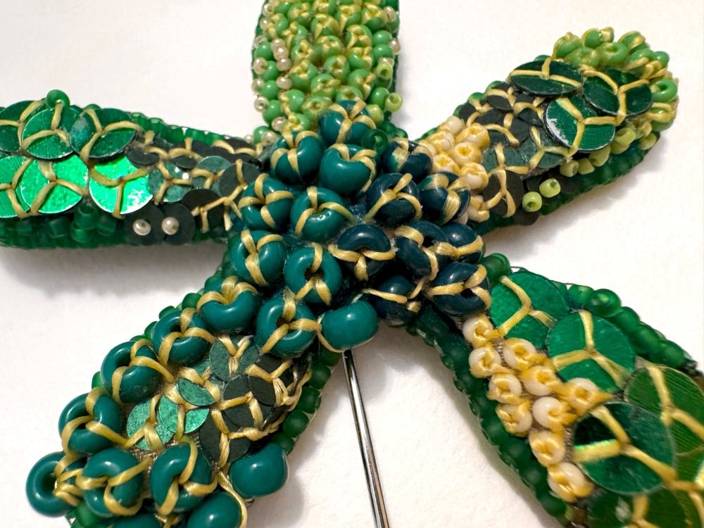 Sculptural handmade brooch inspired by organic forms created with free-flow beadwork in layered greens with yellow accents - Ornamentico shop