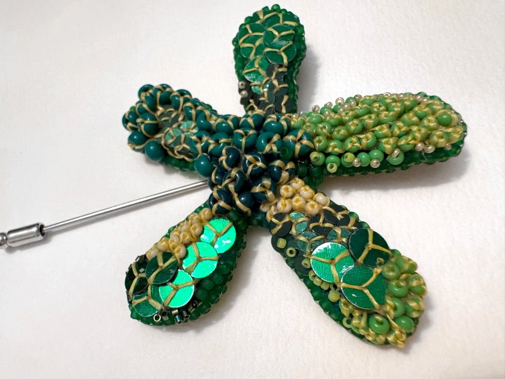 Sculptural handmade brooch inspired by organic forms created with free-flow beadwork in layered greens with yellow accents - Ornamentico shop