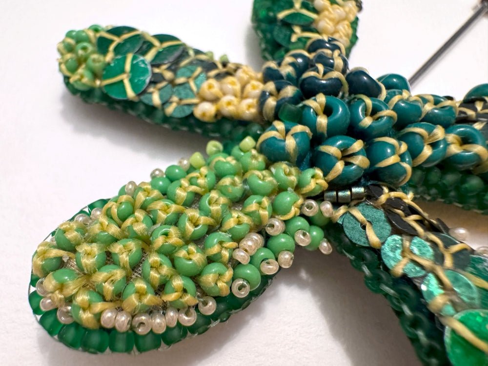 Sculptural handmade brooch inspired by organic forms created with free-flow beadwork in layered greens with yellow accents - Ornamentico shop