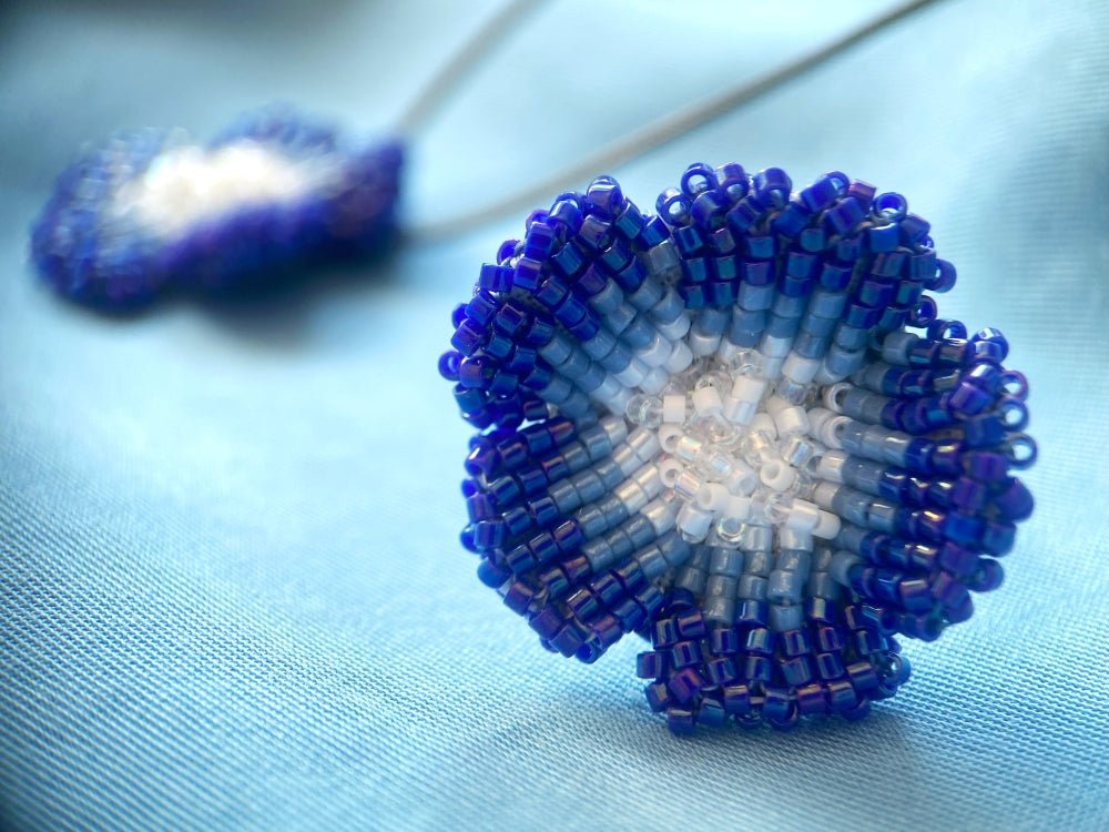 Handcrafted sculptural beaded ring shaped like a blue clematis flower - Ornamentico shop