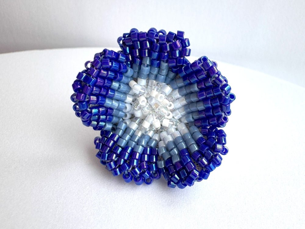 Handcrafted sculptural beaded ring shaped like a blue clematis flower - Ornamentico shop
