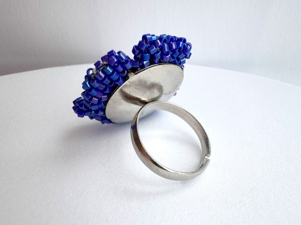 Handcrafted sculptural beaded ring shaped like a blue clematis flower - Ornamentico shop