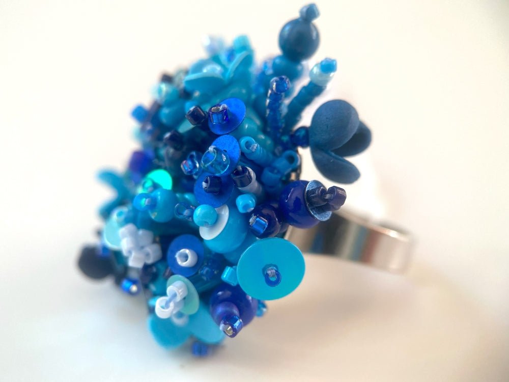 Handmade volume-beaded statement ring with floral design, polymer clay & sequins in blue hues - Ornamentico shop
