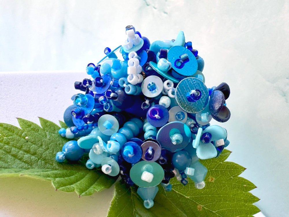 Handmade volume-beaded statement ring with floral design, polymer clay & sequins in blue hues - Ornamentico shop