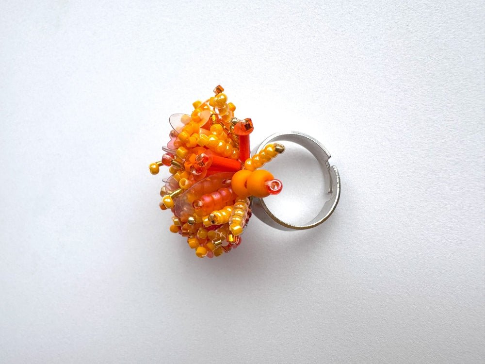 Colorful ring crafted in volume-beading technique from bright orange beads and sequins imitating a blossoming flowerbed - Ornamentico shop