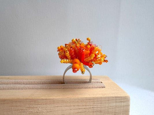 Colorful ring crafted in volume-beading technique from bright orange beads and sequins imitating a blossoming flowerbed - Ornamentico shop