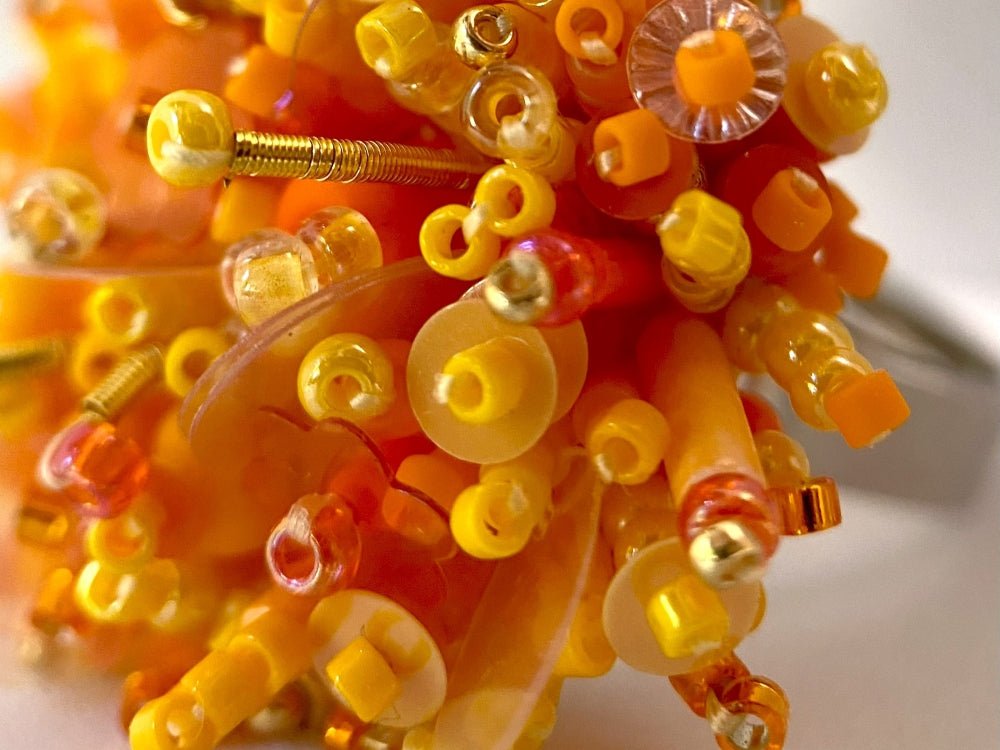Colorful ring crafted in volume-beading technique from bright orange beads and sequins imitating a blossoming flowerbed - Ornamentico shop