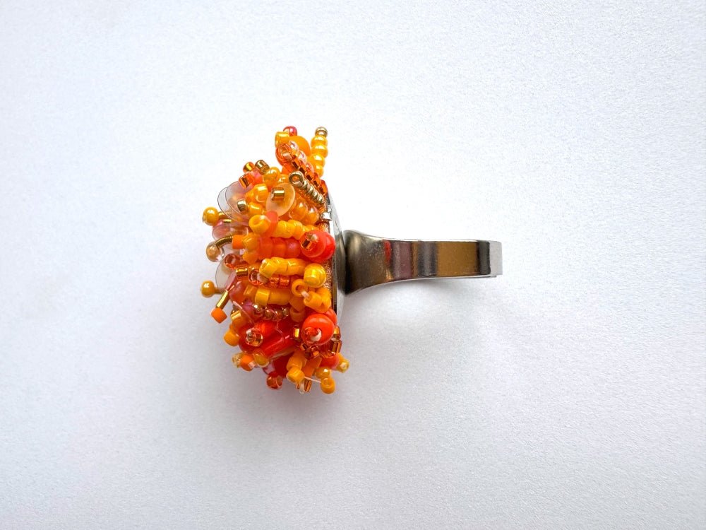Colorful ring crafted in volume-beading technique from bright orange beads and sequins imitating a blossoming flowerbed - Ornamentico shop