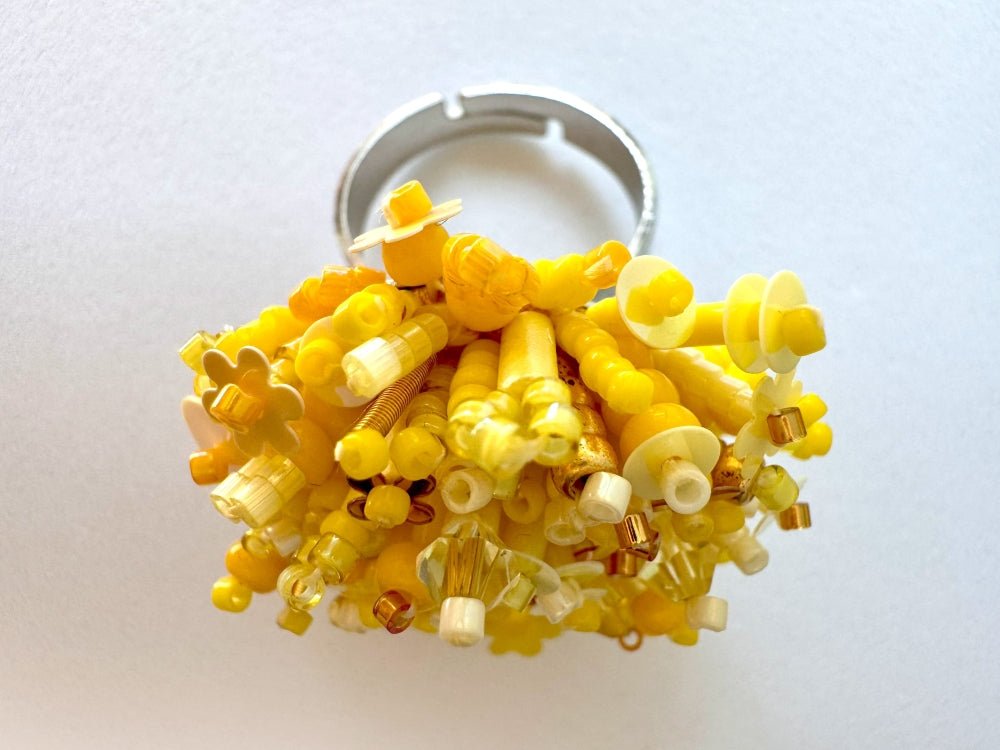 Handmade volume-beaded statement ring with floral design, polymer clay and sequins in yellow hues - Ornamentico shop