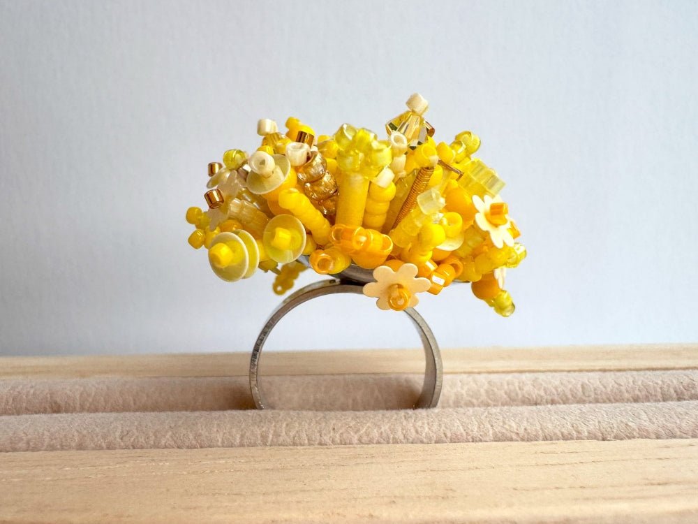 Handmade volume-beaded statement ring with floral design, polymer clay and sequins in yellow hues - Ornamentico shop