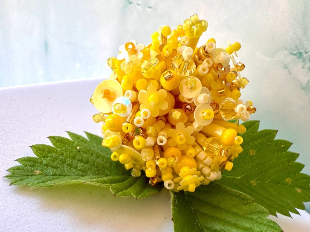 Handmade volume-beaded statement ring with floral design, polymer clay and sequins in yellow hues - Ornamentico shop