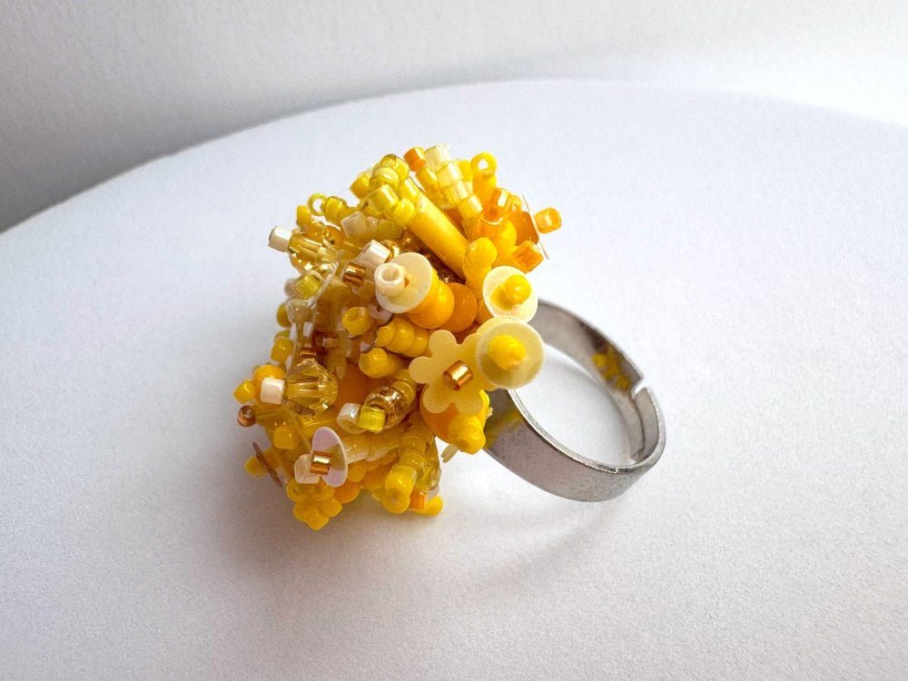 Handmade volume-beaded statement ring with floral design, polymer clay and sequins in yellow hues - Ornamentico shop