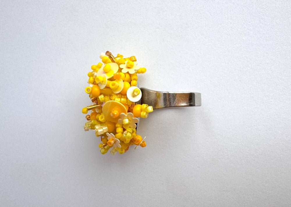 Handmade volume-beaded statement ring with floral design, polymer clay and sequins in yellow hues - Ornamentico shop