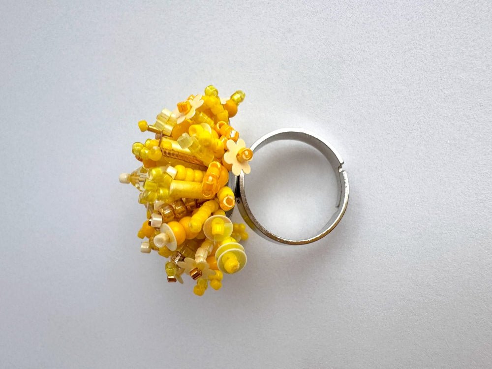 Handmade volume-beaded statement ring with floral design, polymer clay and sequins in yellow hues - Ornamentico shop