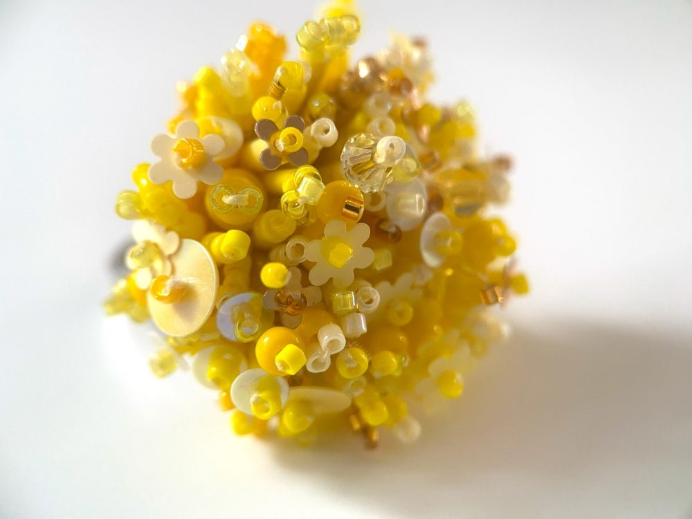 Handmade volume-beaded statement ring with floral design, polymer clay and sequins in yellow hues - Ornamentico shop