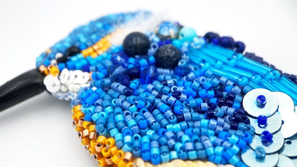 Handmade beaded brooch in the shape of a kingfisher made from glass beads, sequins, bugle beads and rhinestones