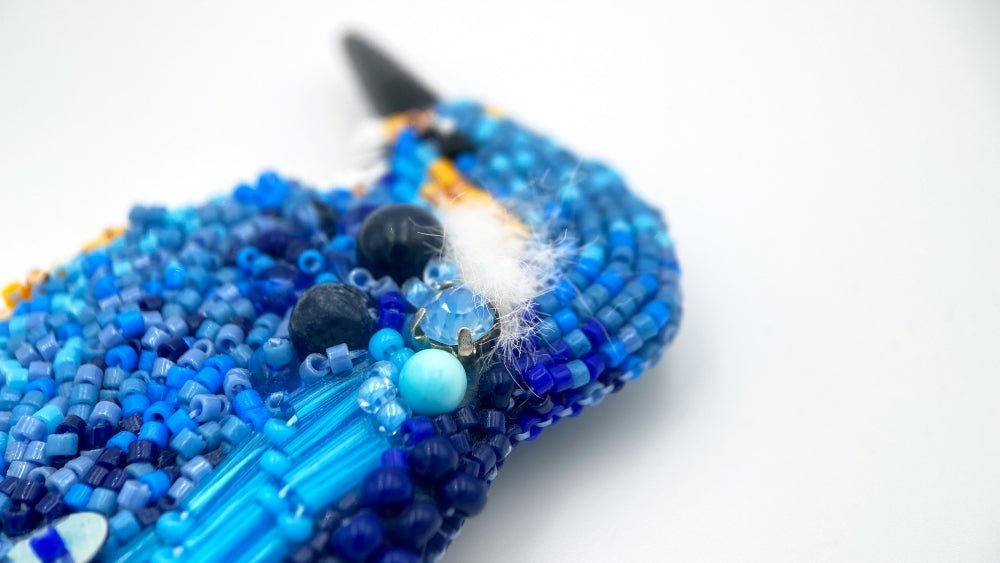 Handmade beaded brooch in the shape of a kingfisher made from glass beads, sequins, bugle beads and rhinestones