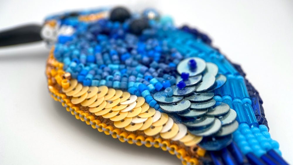 Handmade beaded brooch in the shape of a kingfisher made from glass beads, sequins, bugle beads and rhinestones
