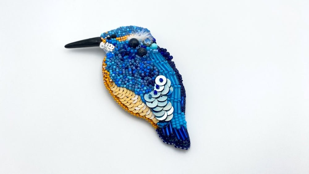 Handmade beaded brooch in the shape of a kingfisher made from glass beads, sequins, bugle beads and rhinestones