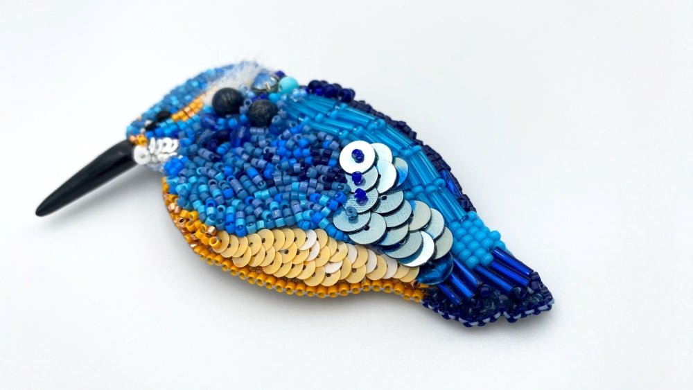 Handmade beaded brooch in the shape of a kingfisher made from glass beads, sequins, bugle beads and rhinestones